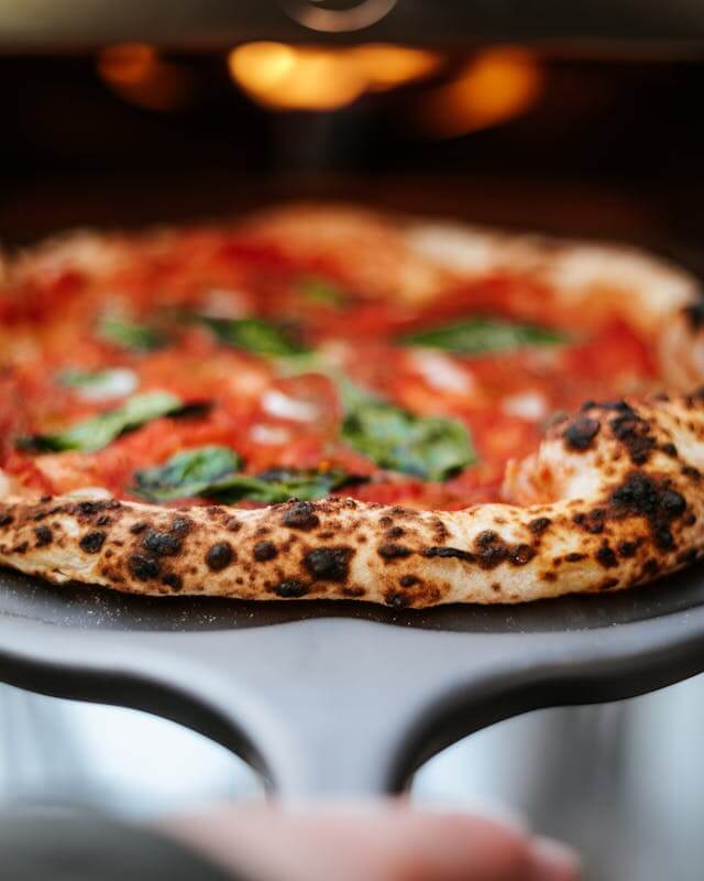 A Close-up of a Neapolitan Pizza on a Pizza Peel