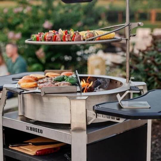 Cooking skewers of vegetables and meat, corn, and burgers on a Breeo grill.