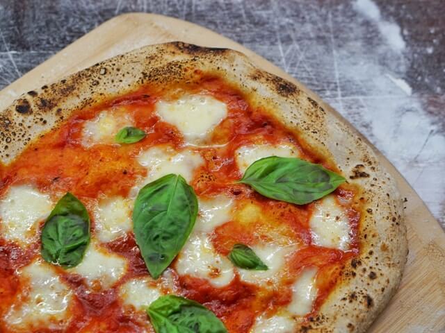 Close-up of authentic Neapolitan Margherita pizza with tomato sauce, fresh mozzarella, and basil