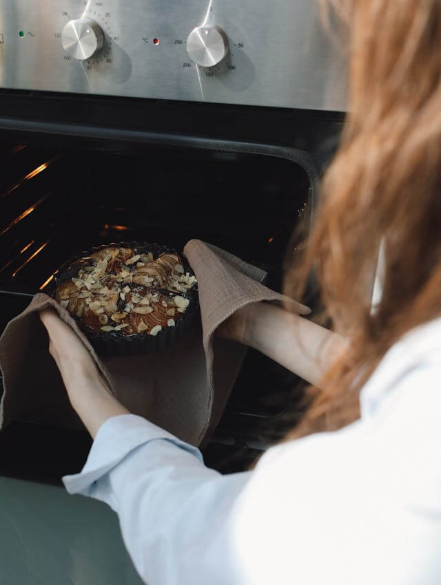 Placing baked food into an oven during cooking