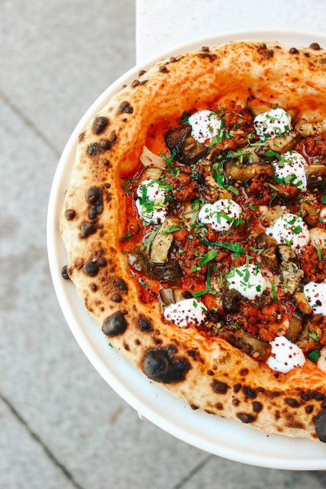 Neapolitan pizza with leopard spots on the crust showing perfect charring and blistering