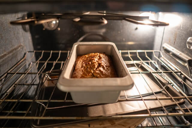 Bread loaf baking inside an oven with the door closed